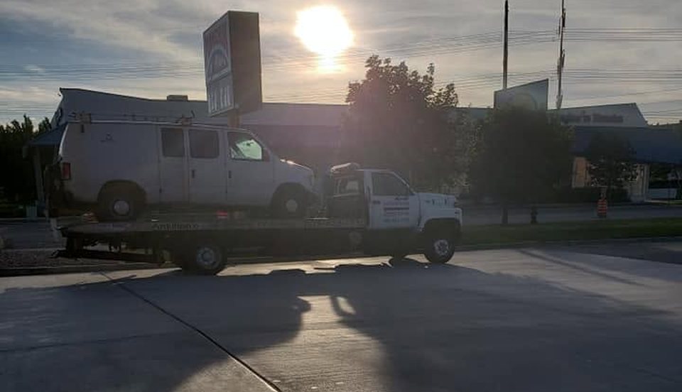 Cargo van loaded on an Antillon's flatbed at sunrise